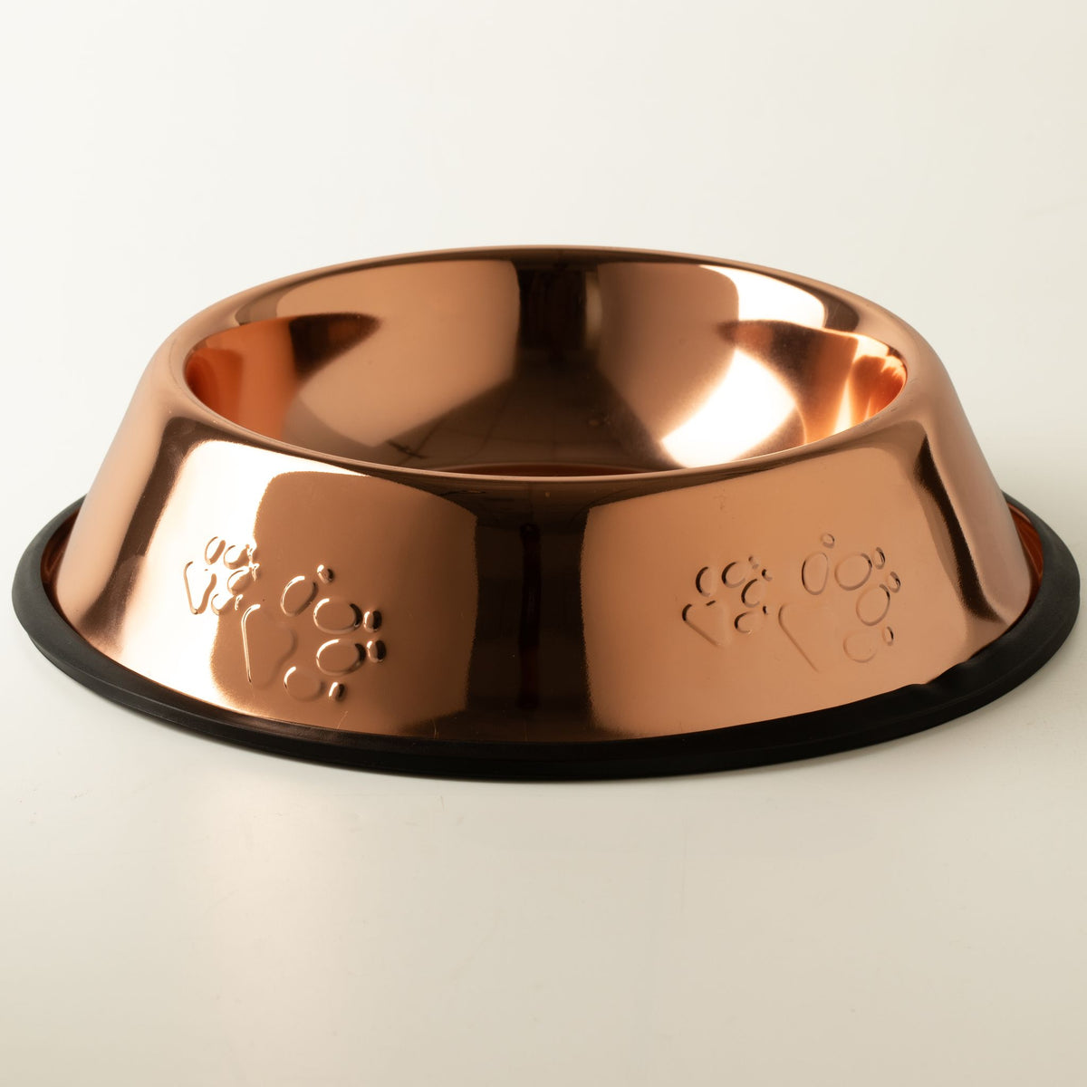 Rose gold metal pet bowl with paw print engravings and non-slip base.