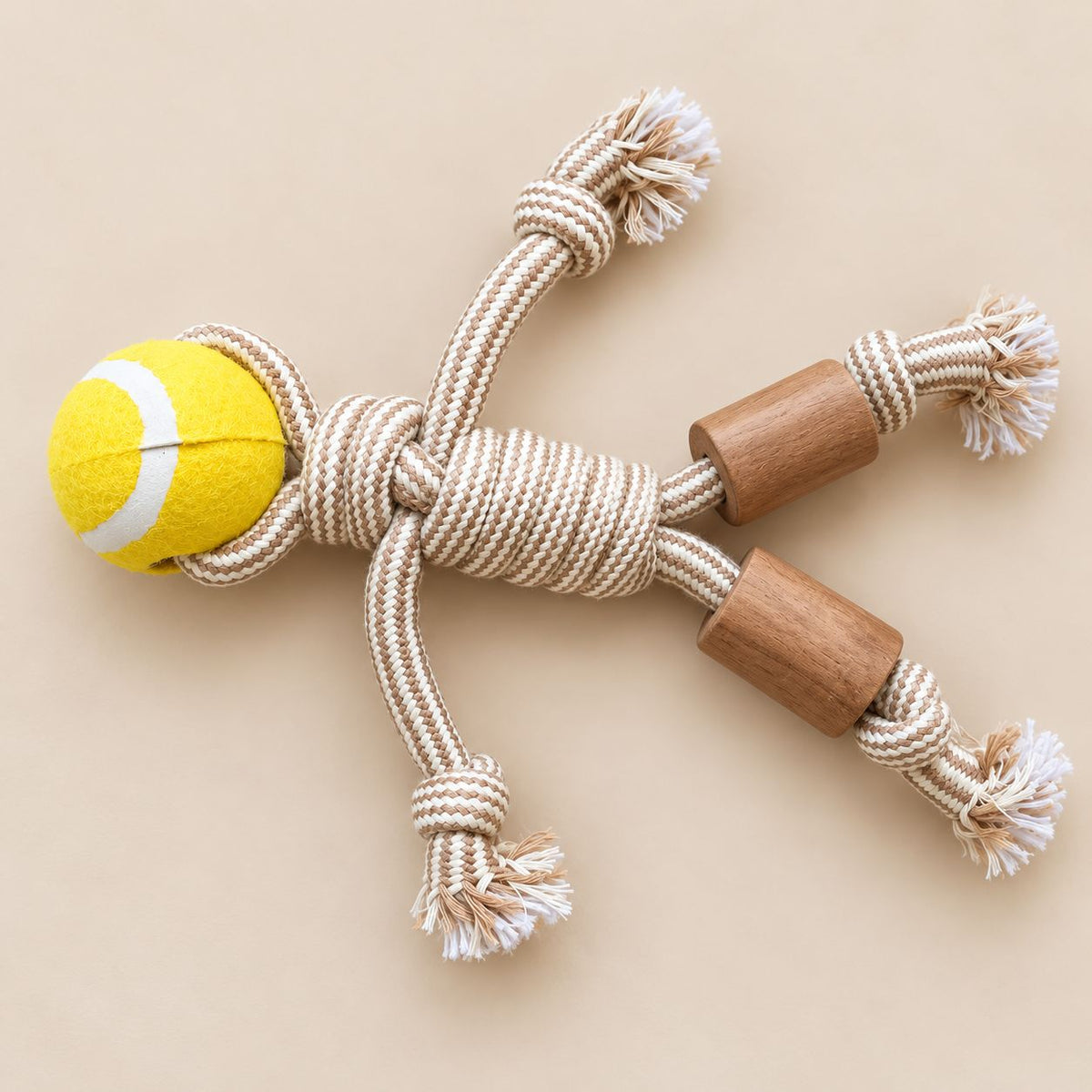 Durable rope dog toy with a yellow tennis ball and wooden beads on a neutral background.